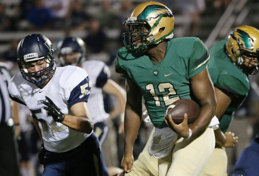 DeSoto quarterback Courtney Douglas (12) rushes 36 yards with Jesuit linebacker Tommy...