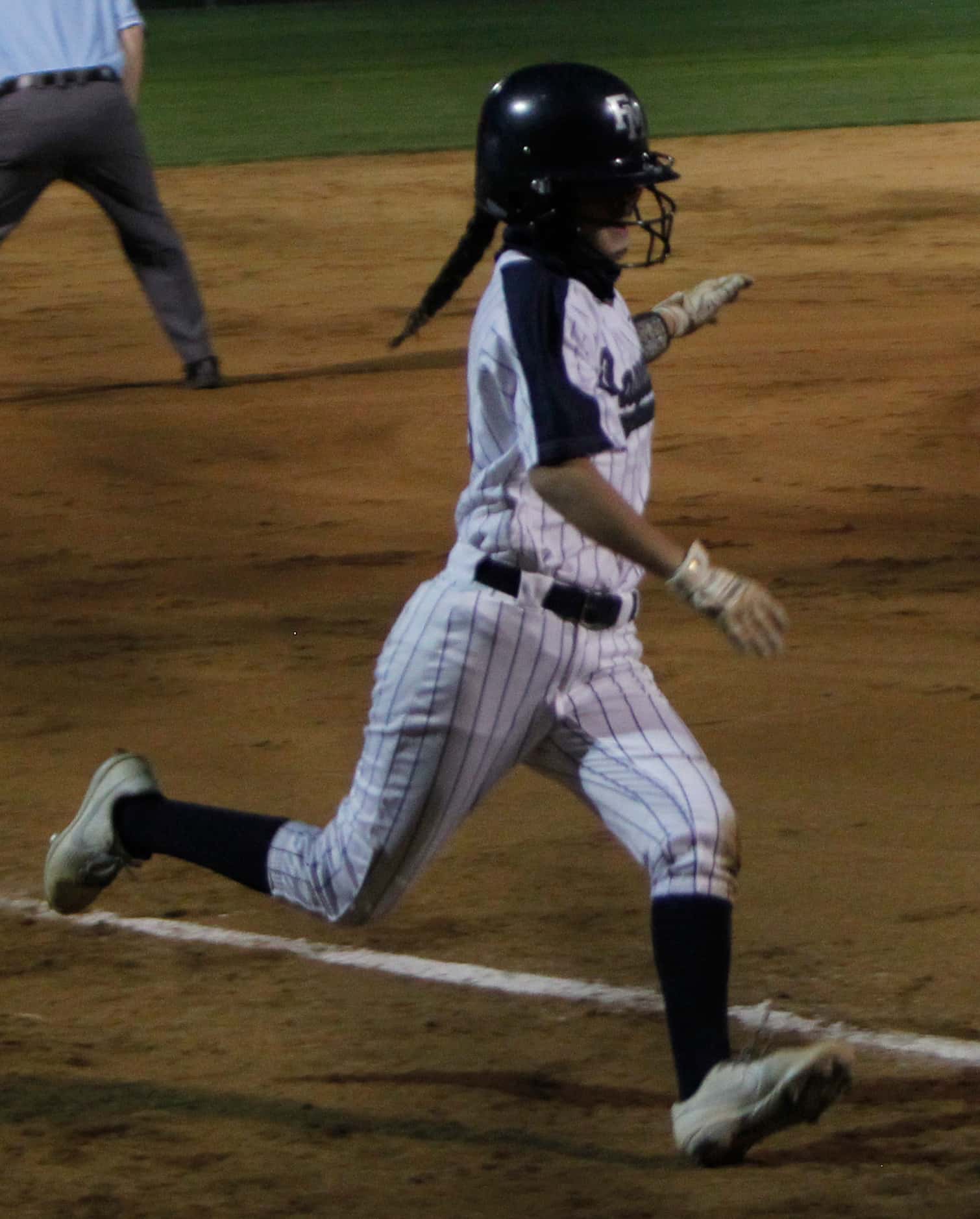 Flower Mound shortstop Ashlyn Brothers (21) scampers home to score as part of a 6-run rally...