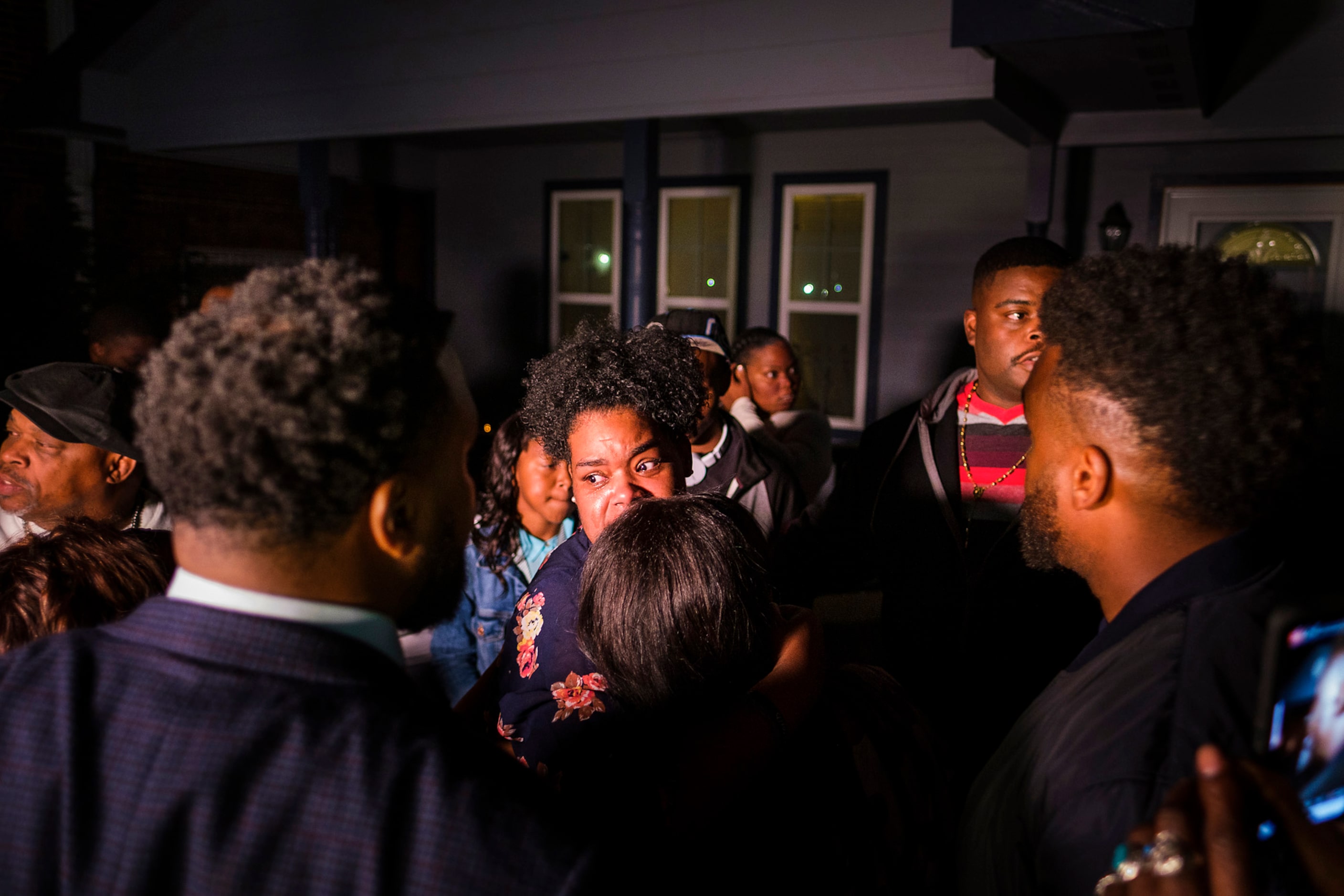 Members of the victimÕs family gather in the front yard of the house where Atatiana...