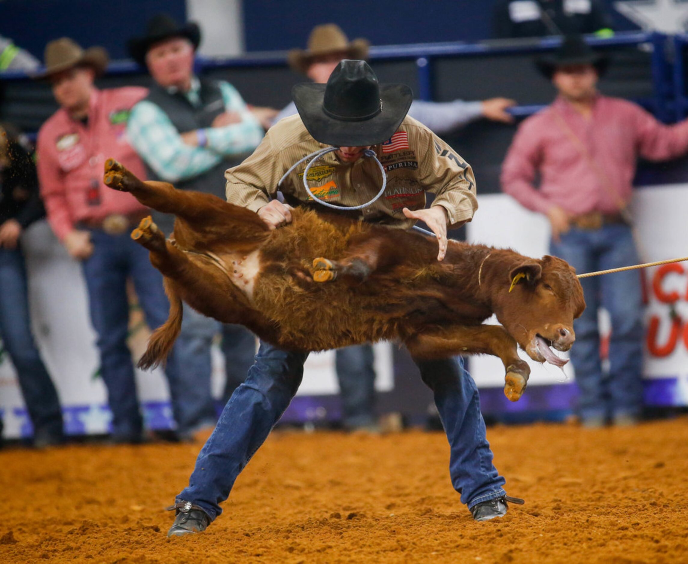 Haven Meged grabs the calf during the tie-down roping competition of RFD-TV's The American...