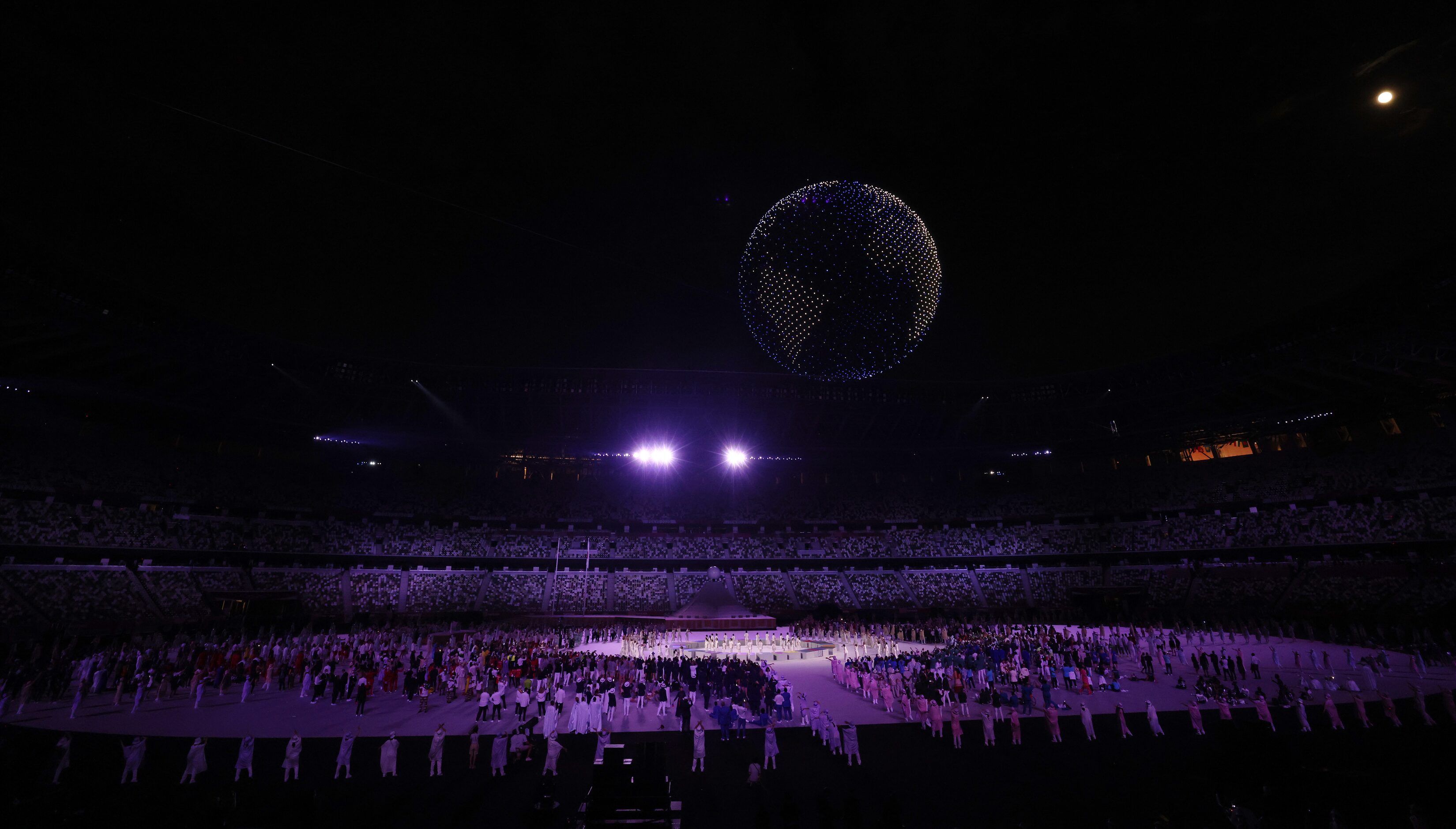 Drones make a formation during the opening ceremony for the postponed 2020 Tokyo Olympics at...