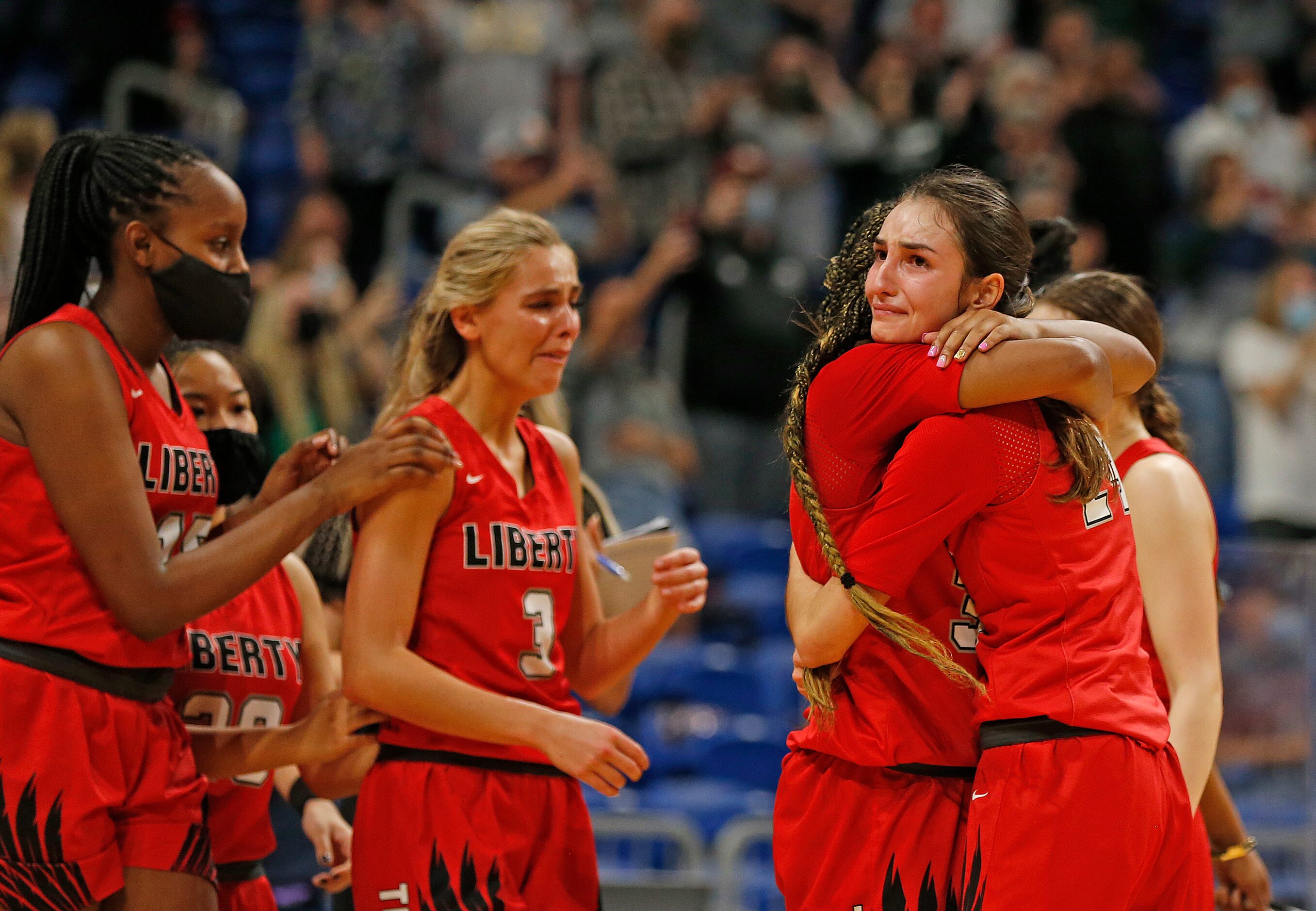 Frisco Liberty Maya Jain #24 hugs Frisco Liberty Jazzy Owens-Barnett #30 at the end of the...