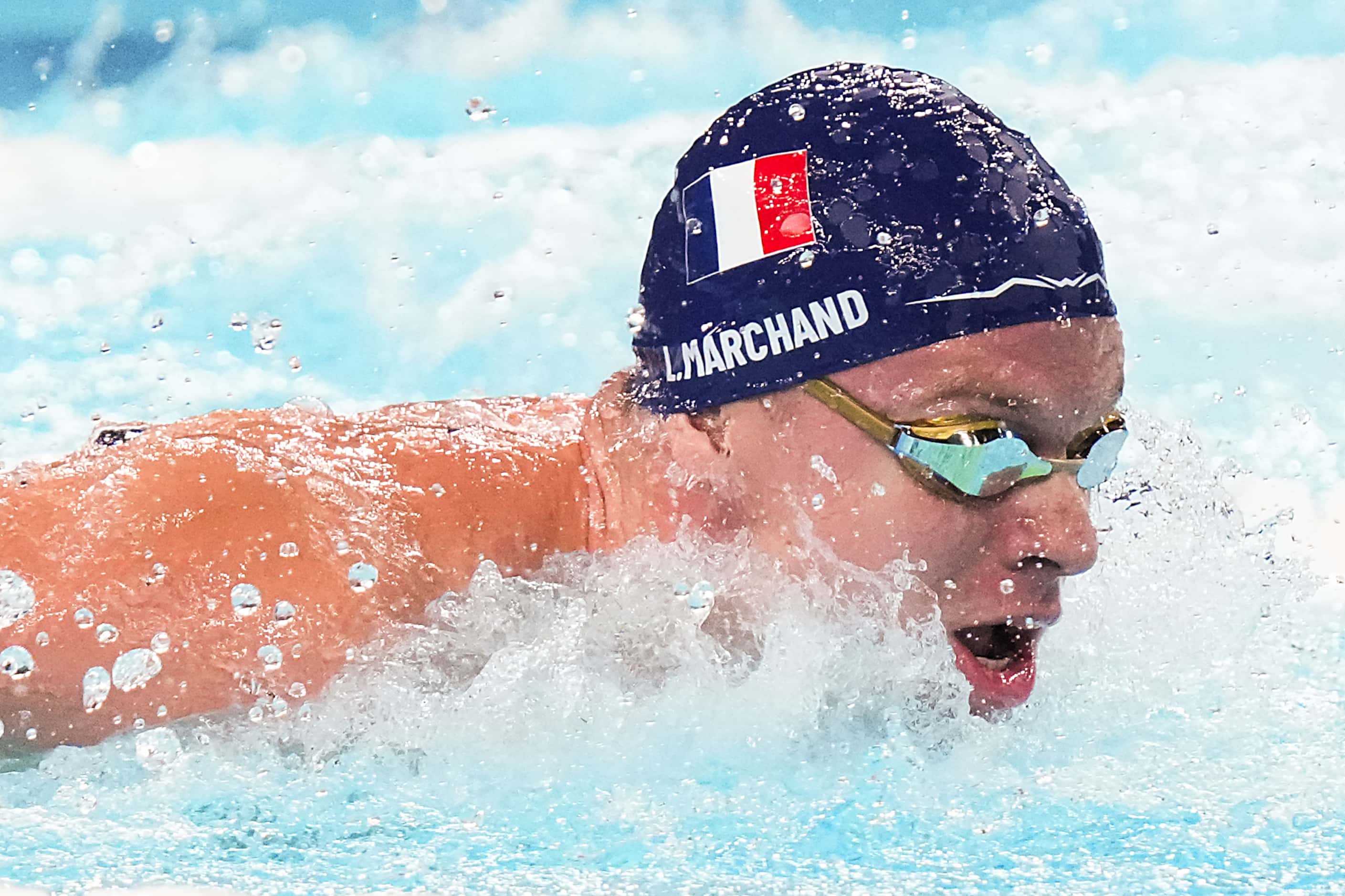 Leon Marchand of France swims to a victory in the men’s 200-meter butterfly final at the...