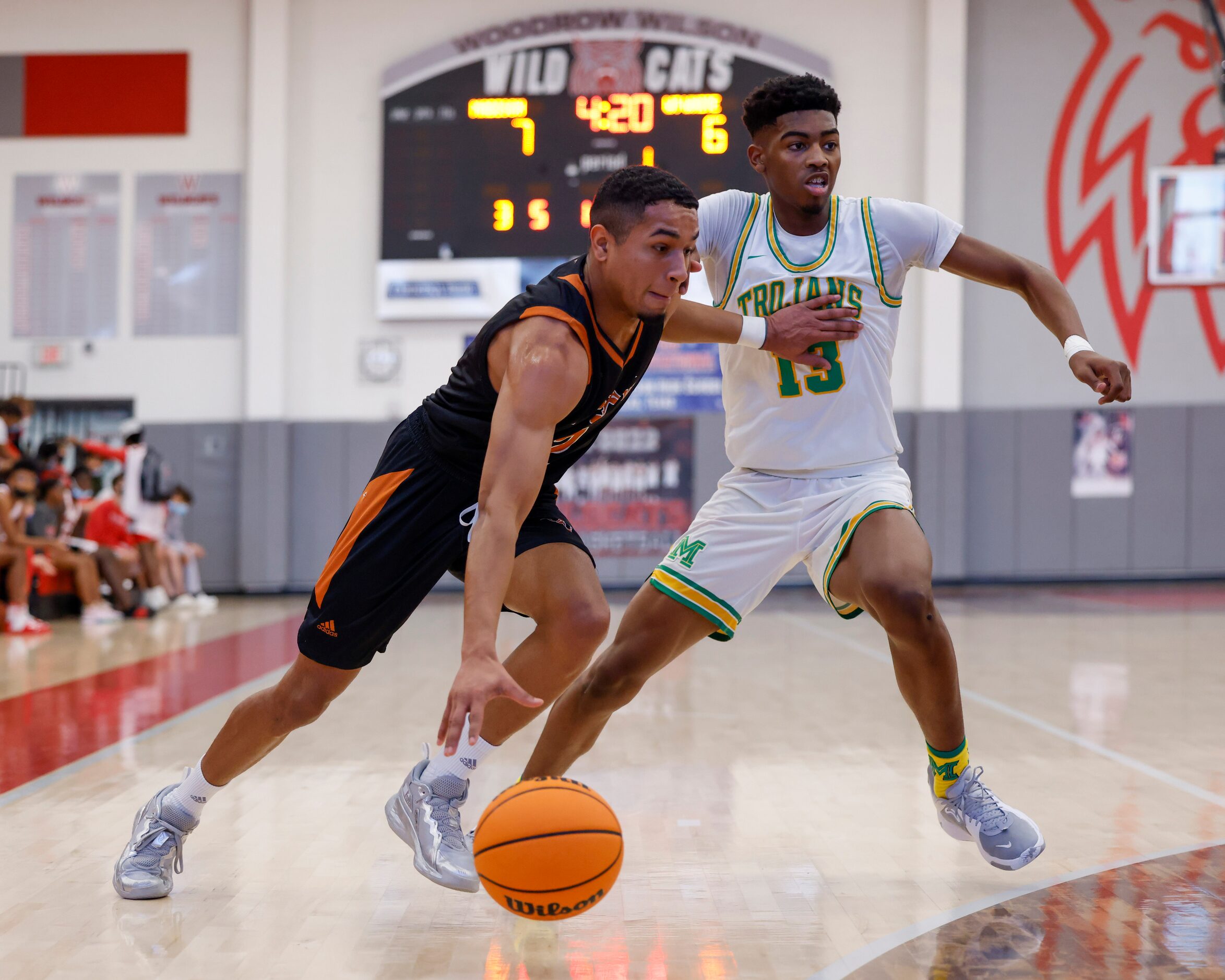 W.T. White guard Raul Nieves (2) drives past Madison forward Quintin Spencer (13) during the...