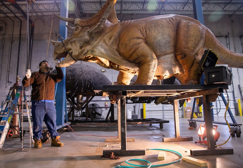 Alberto Hernandez checks the movement of a dinosaur at Billings Productions, an animatronic...