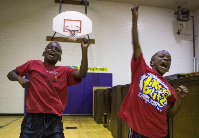 Cody Crawford (left) and Jadean Mathis participate in a morning session of Harambee cheers...