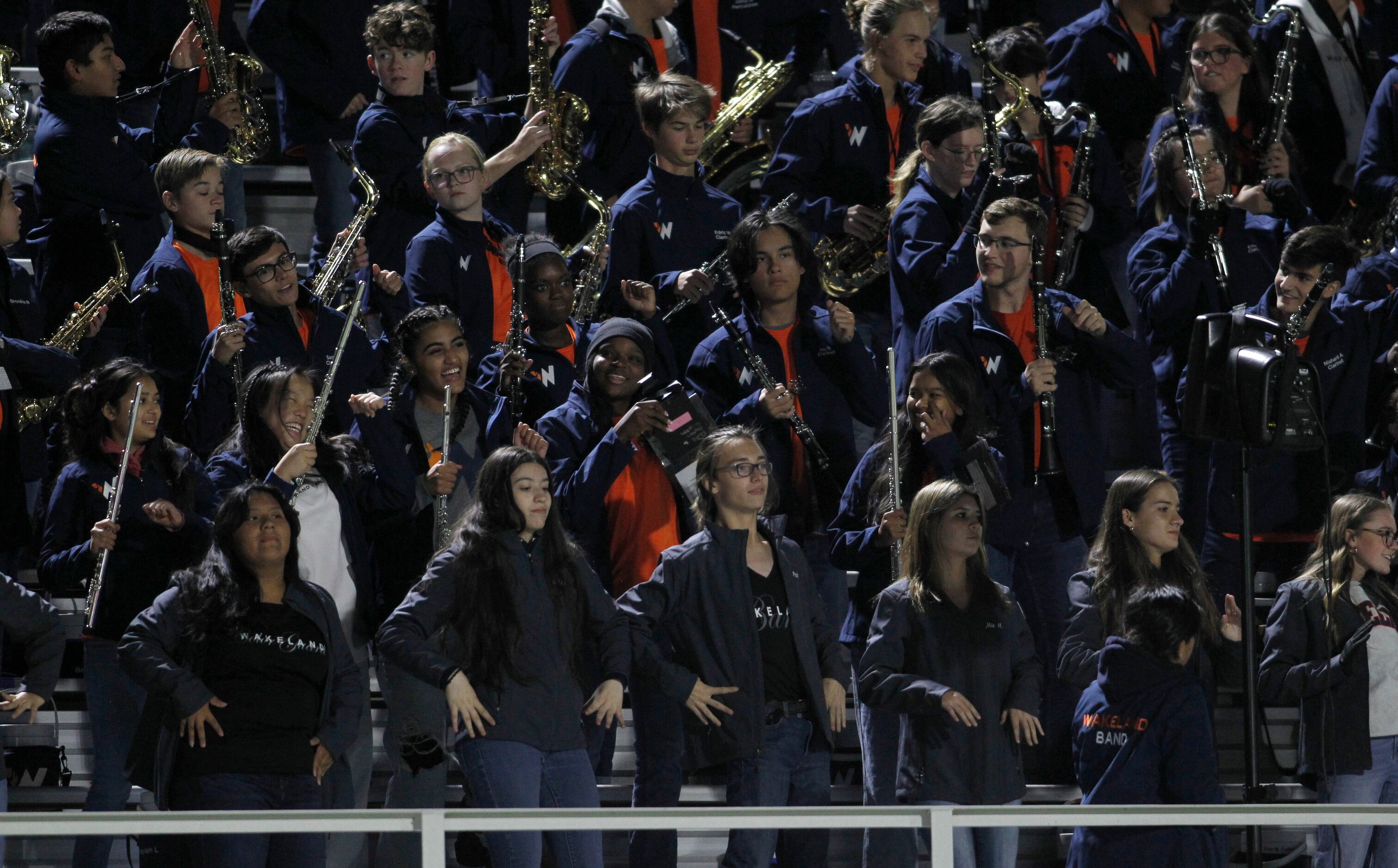 Members of the Frisco Wakeland band dance from the stands during 2nd quarter action of the...