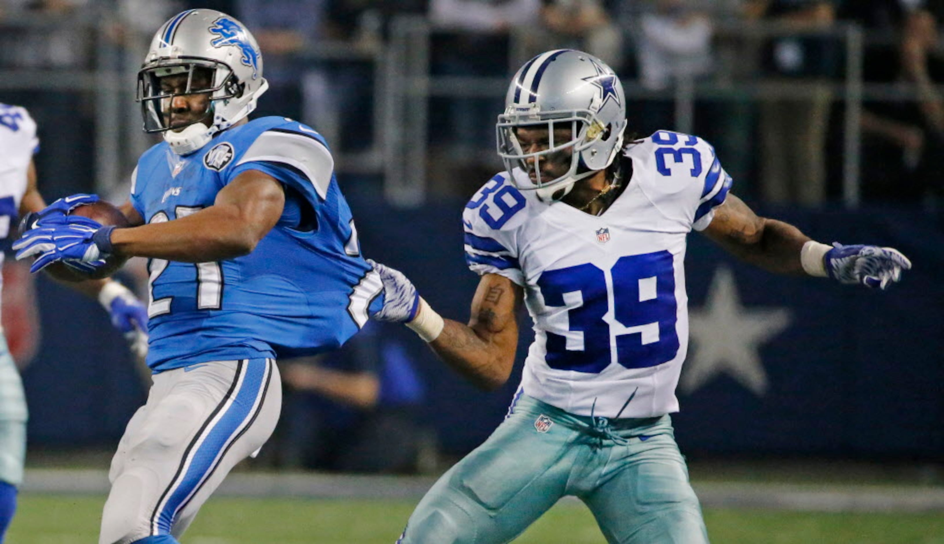 The Dallas Cowboys' Brandon Carr, left, looks on as teammate Dez