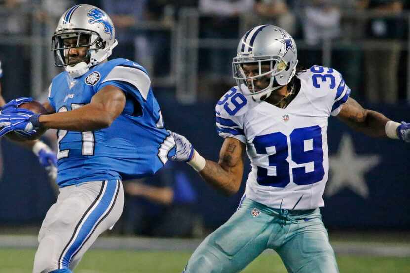 Dallas Cowboys cornerback Brandon Carr (39) drags down Detroit Lions running back Reggie...