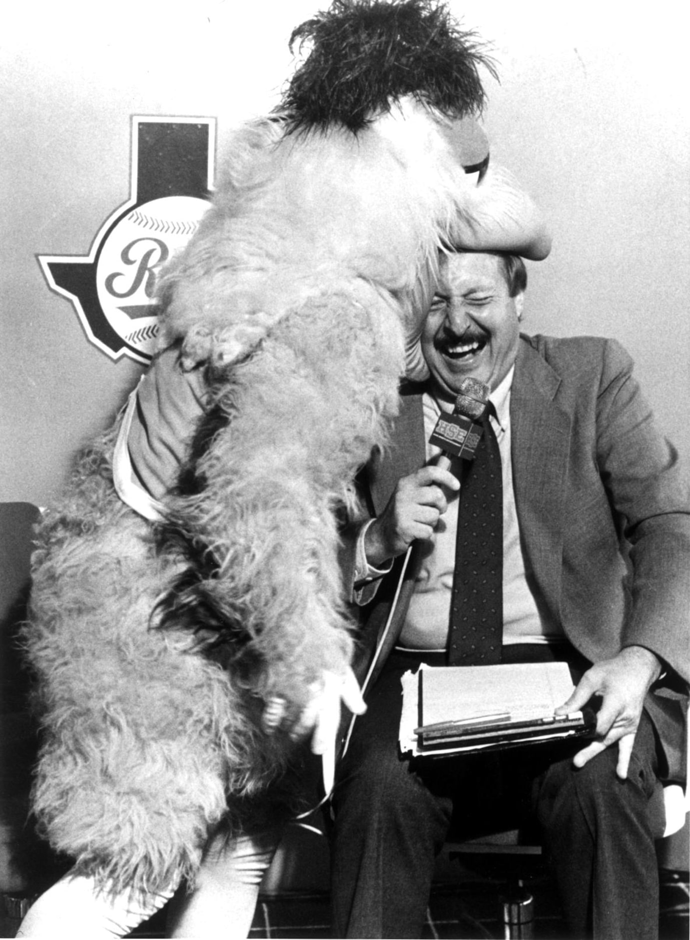 Norm Hitzges at a pregame Rangers talk show with the Chicken.