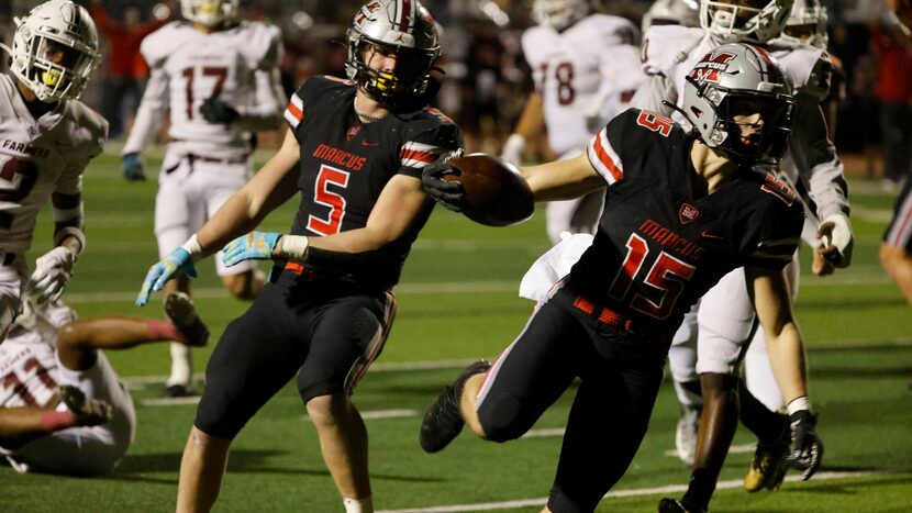 Flower Mound Marcus running back gAb Espinoza (15), scores a touchdown against Lewisville as...