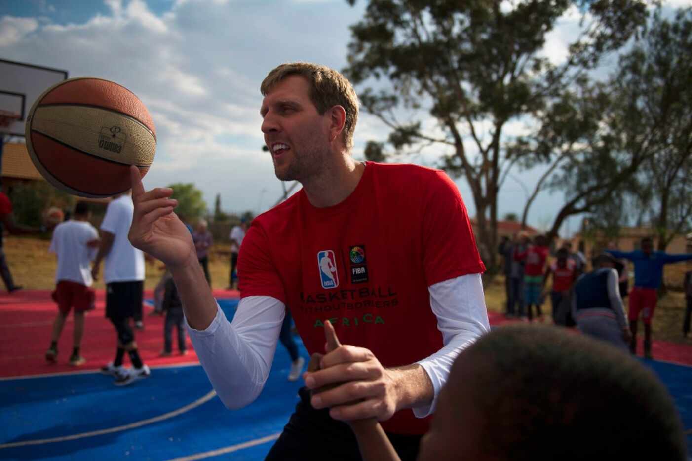 Dirk Nowitzki of the Dallas Mavericks and other NBA players from various countries interact...