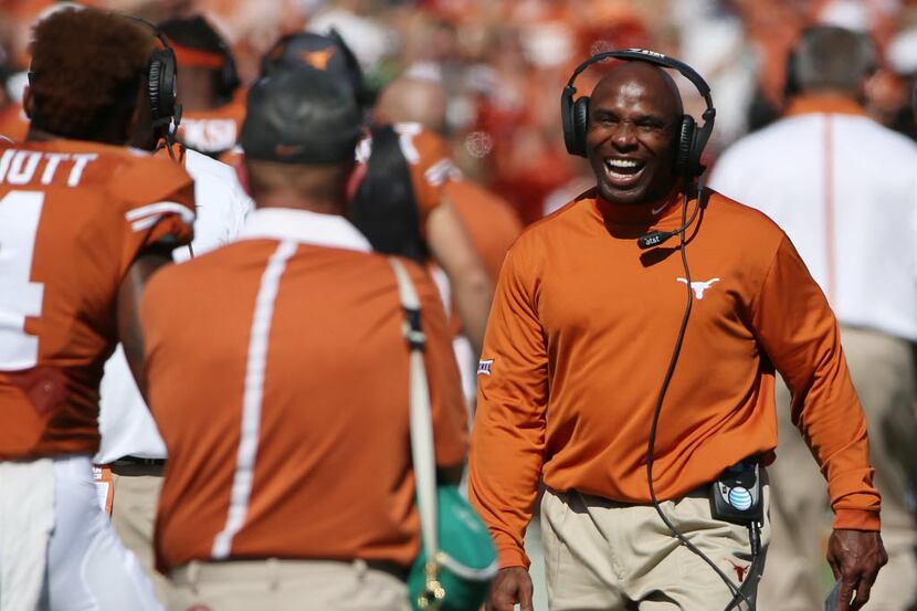 Texas Longhorns head coach Charlie Strong celebrates after a fumble recovery call in favor...