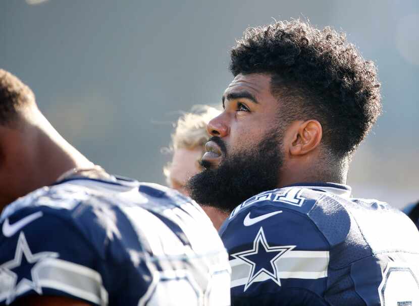 Dallas Cowboys running back Ezekiel Elliott looks up as during the national anthem before...