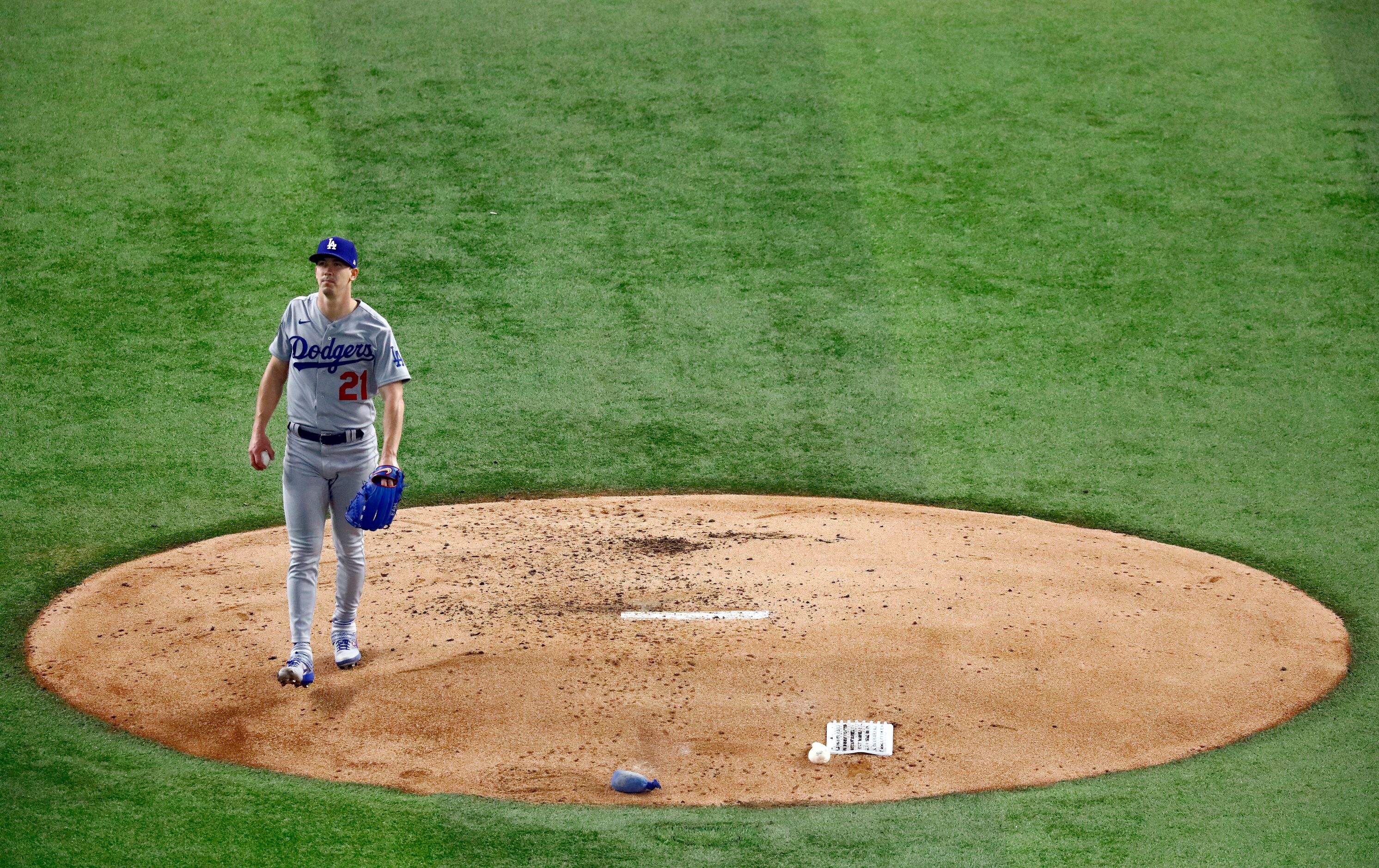 Los Angeles Dodgers starting pitcher Walker Buehler (21) walks off the mound after striking...