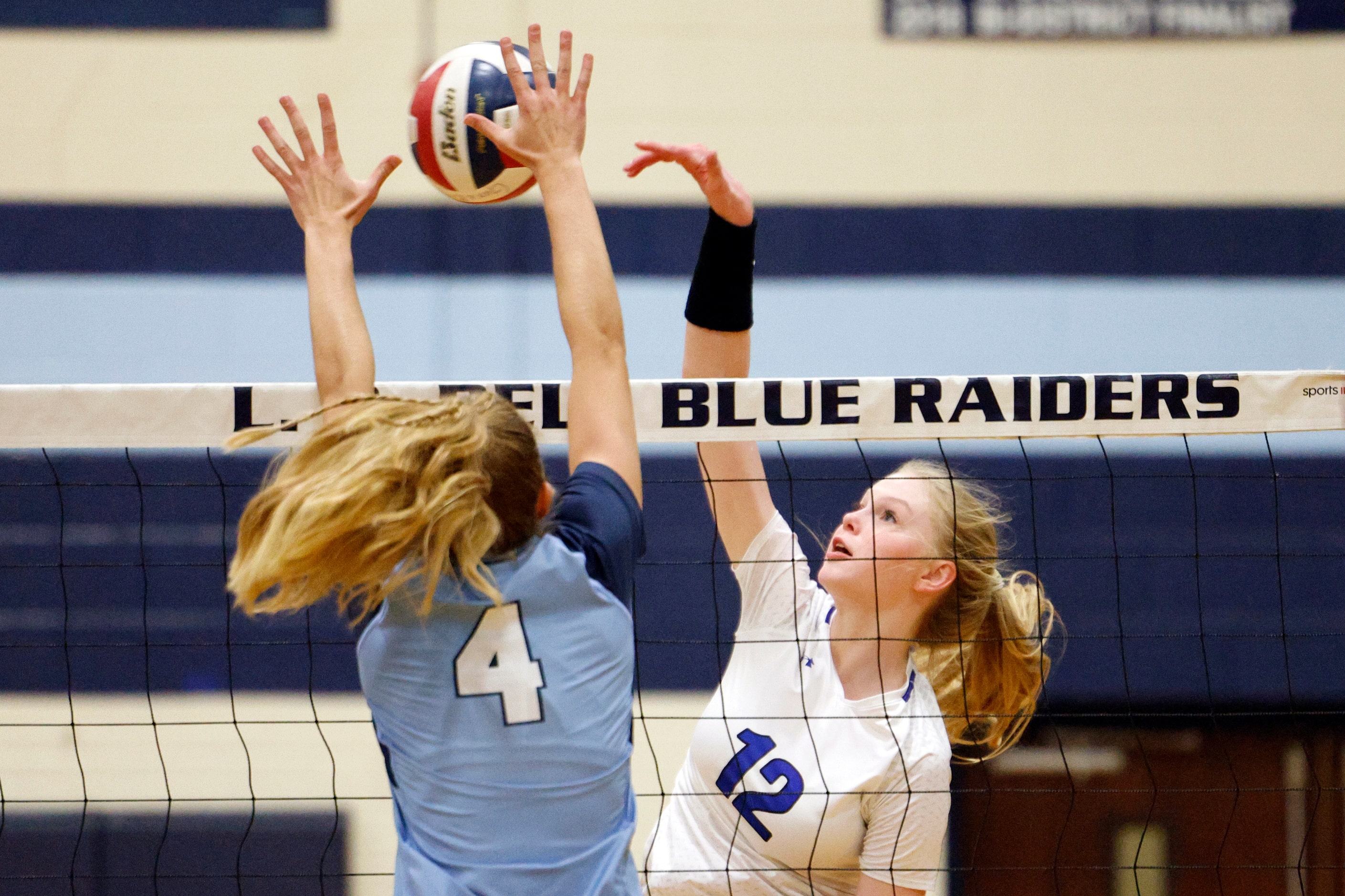 Trophy Club Byron Nelson's Ashlyn Seay (12) hits into the block of L.D. Bell's Natalie Roach...