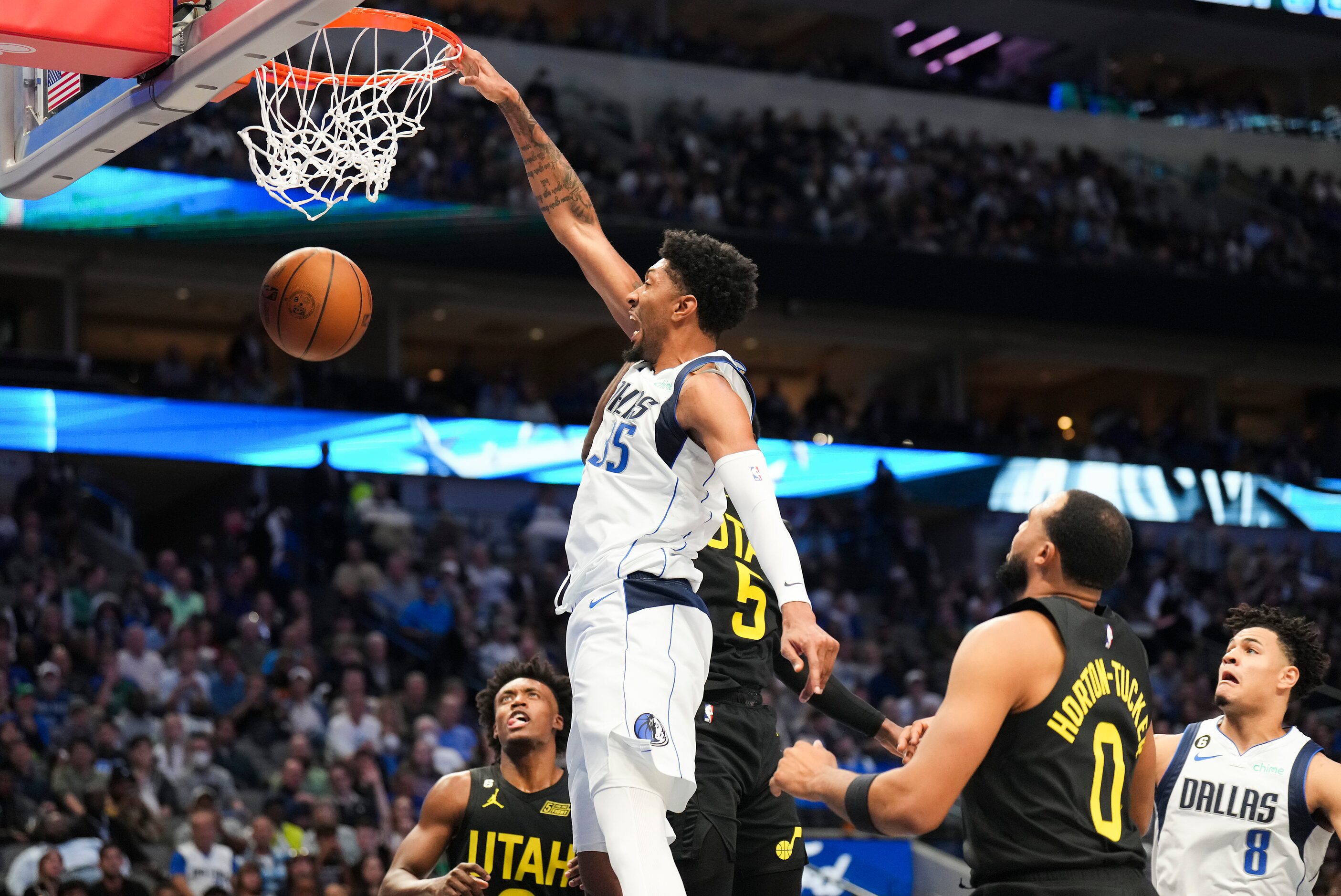 Dallas Mavericks center Christian Wood (35) dunks the ball past Utah Jazz guard Collin...