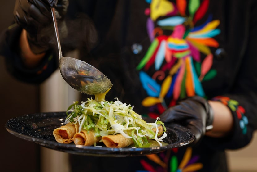 Martina de la Guti, owner of Santa Maria Mexican food catering, prepares tacos ahogados...