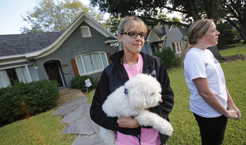 Libby Franks (holding "Lola") and Kara Lutley watch the action down the block on Marquita as...