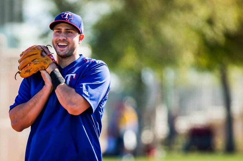 Texas Rangers third baseman Joey Gallo laughs while participating in a defensive drill...