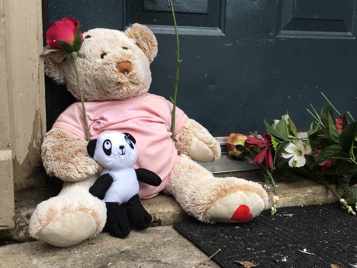 Teddy bears and flowers were set outside the door of the Red Bird apartment where 3-year-old...