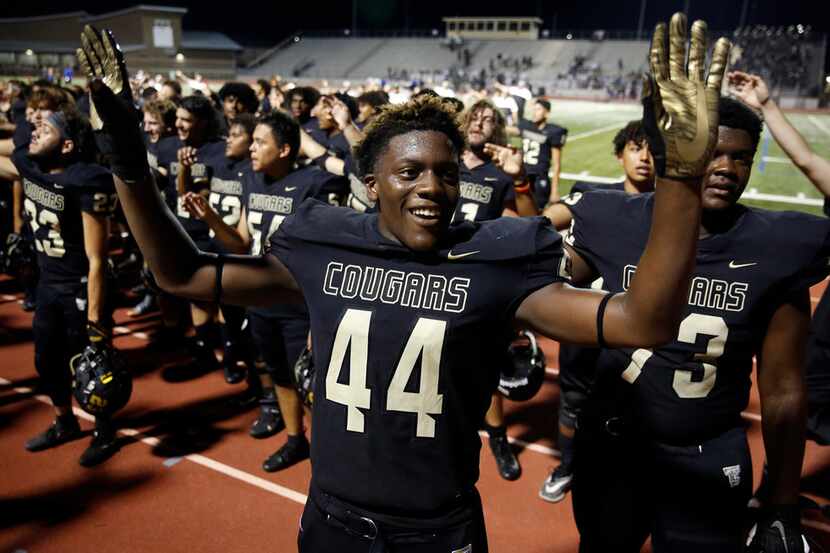 The Colony defensive end Kyair Warner (44) directs the band as they sing the school song...