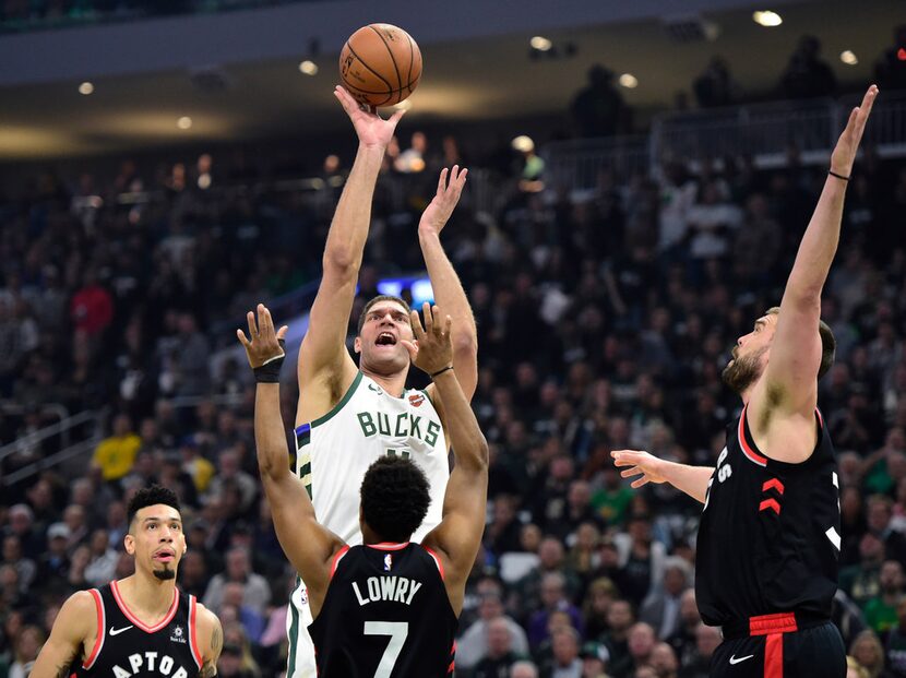 Milwaukee Bucks center Brook Lopez (11) shoots over Toronto Raptors guard Kyle Lowry (7)...