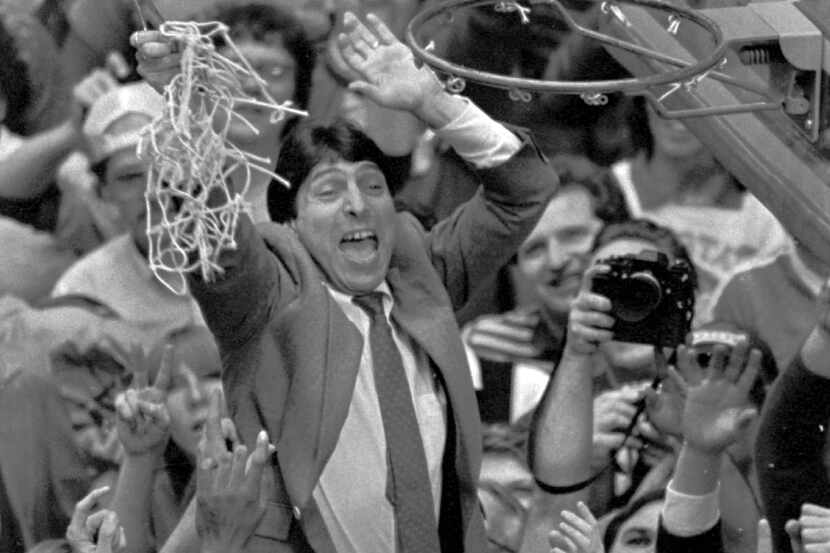 In this April 4, 1983 file photo, North Carolina State coach Jim Valvano holds the net aloft...