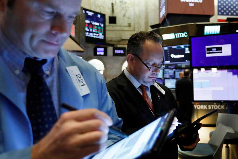 Traders work on the floor of the New York Stock Exchange. in May.  Don't buy stocks just...
