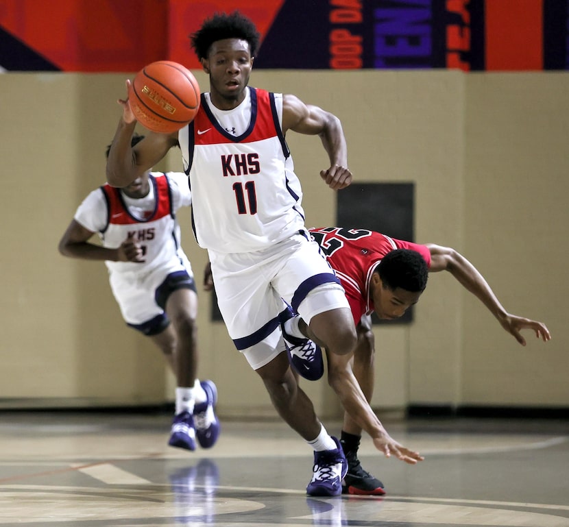 Kimball forward Barack Holland (11) gets a steal from Woodrow Wilson guard Kameron Loyd (22)...