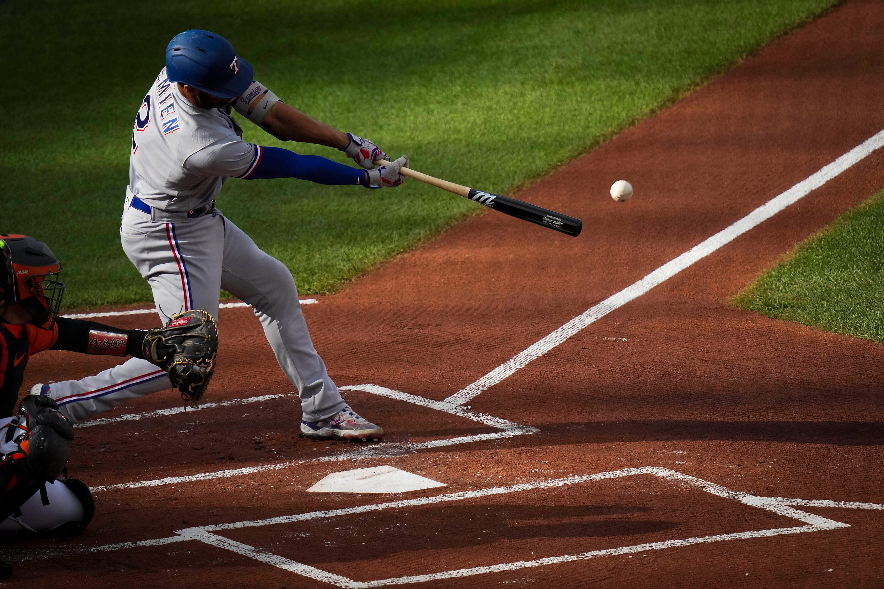 Texas Rangers second baseman Marcus Semien hits a leadoff single during the first inning in...