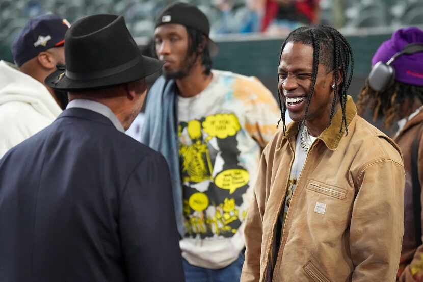 Former baseball player Reggie Jackson and entertainer Travis Scott share a laugh prior to...