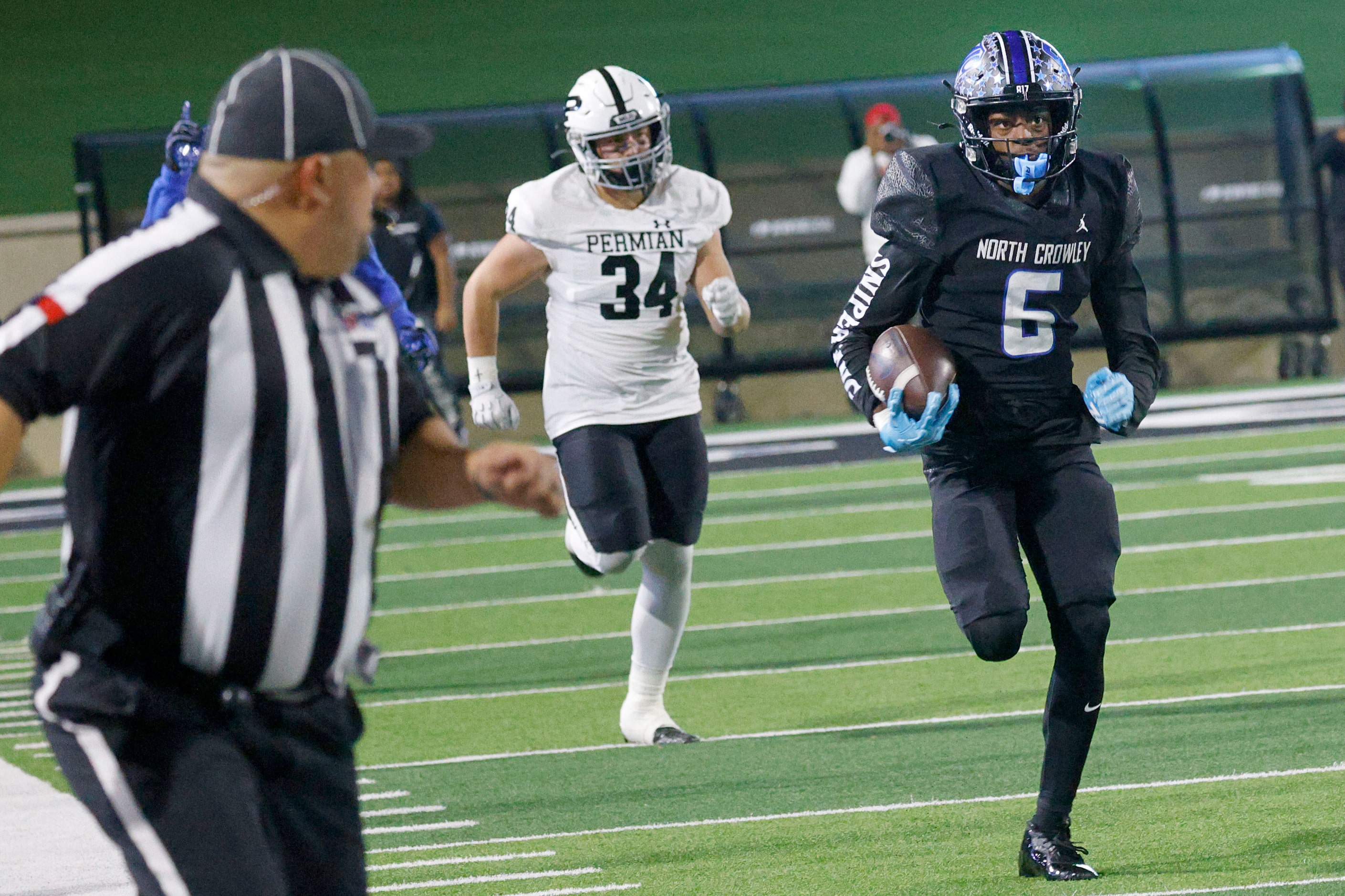 North Crowley's Quentin Gibson runs for a touchdown as Permian's Jayson Cranfill (34)...