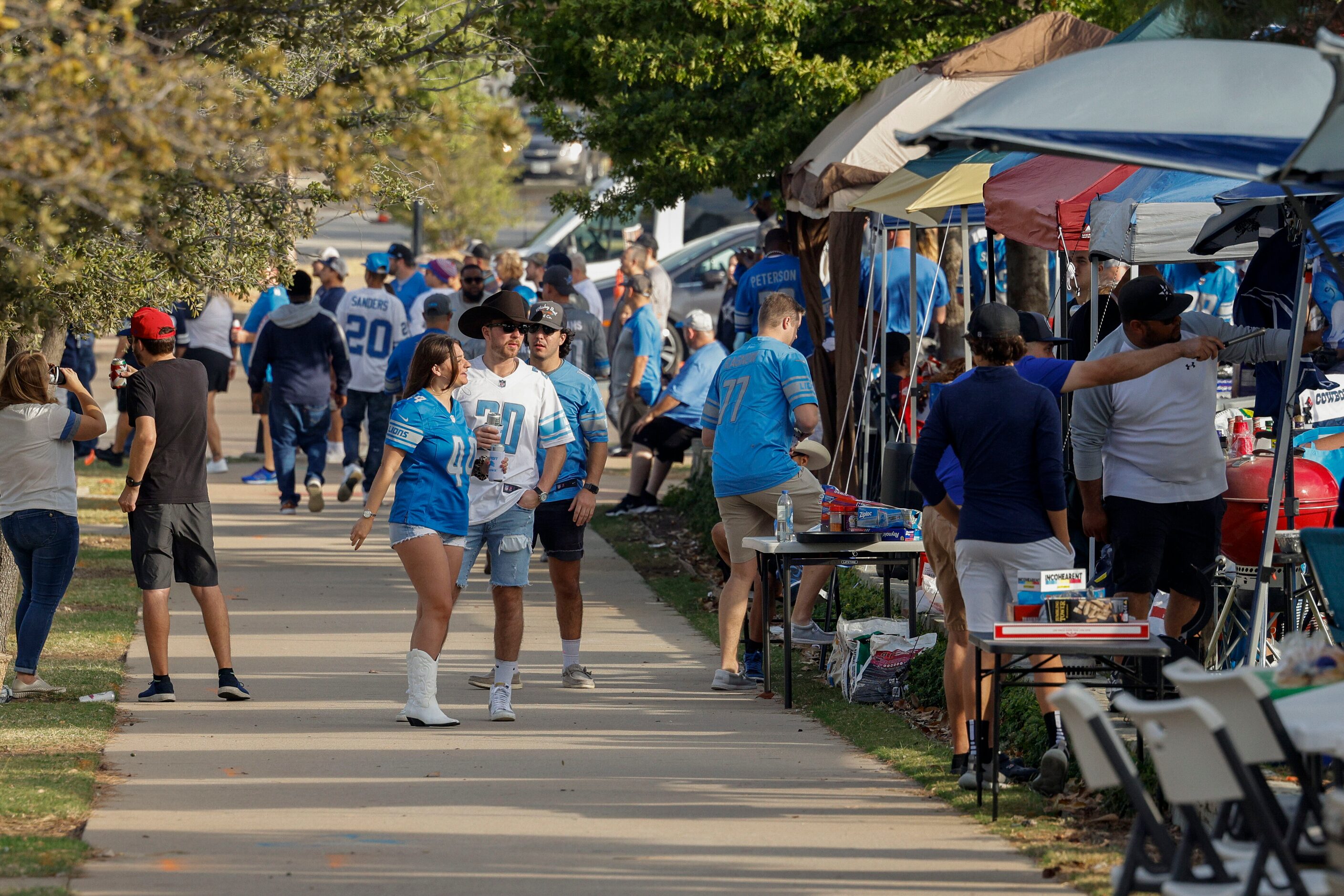 Football fans tailgate before a Dallas Cowboys and Detroit Lions game at AT&T Stadium on...