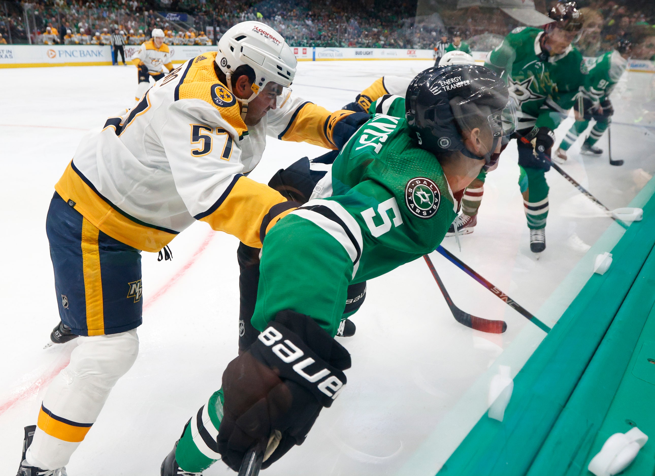 Nashville Predators defenseman Dante Fabbro (57) checks Dallas Stars defenseman Nils...