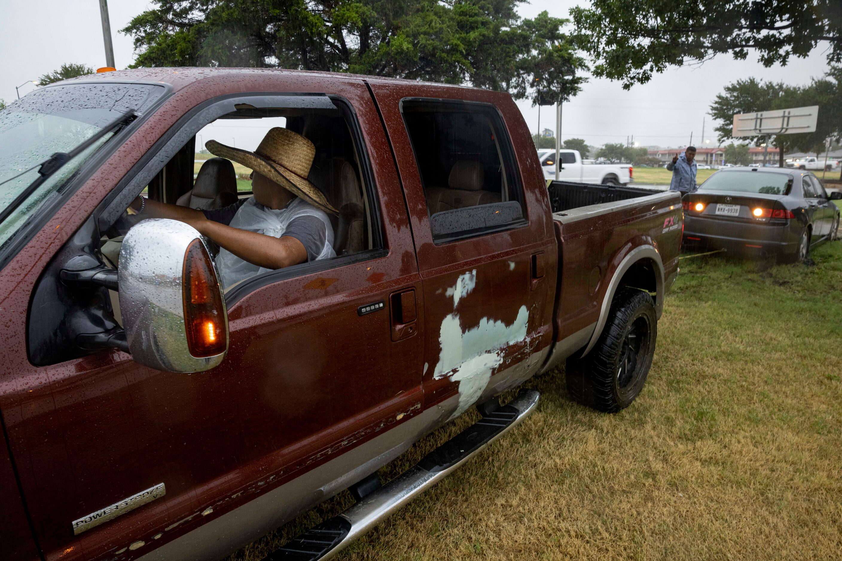 Daniel Vasquez with the help of his dad, brother and cousin uses his pickup to pull Herson...