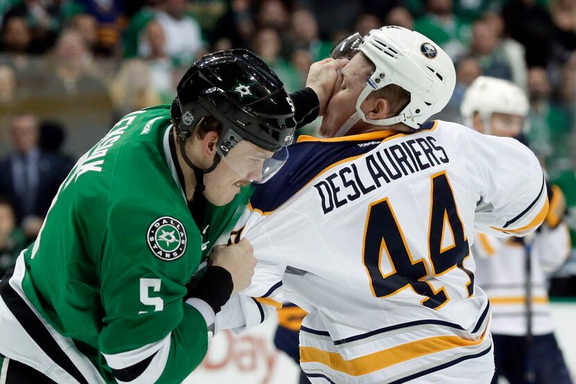 Dallas Stars' Jamie Oleksiak (5) lands a punch as he fights Buffalo Sabres' Nicolas...