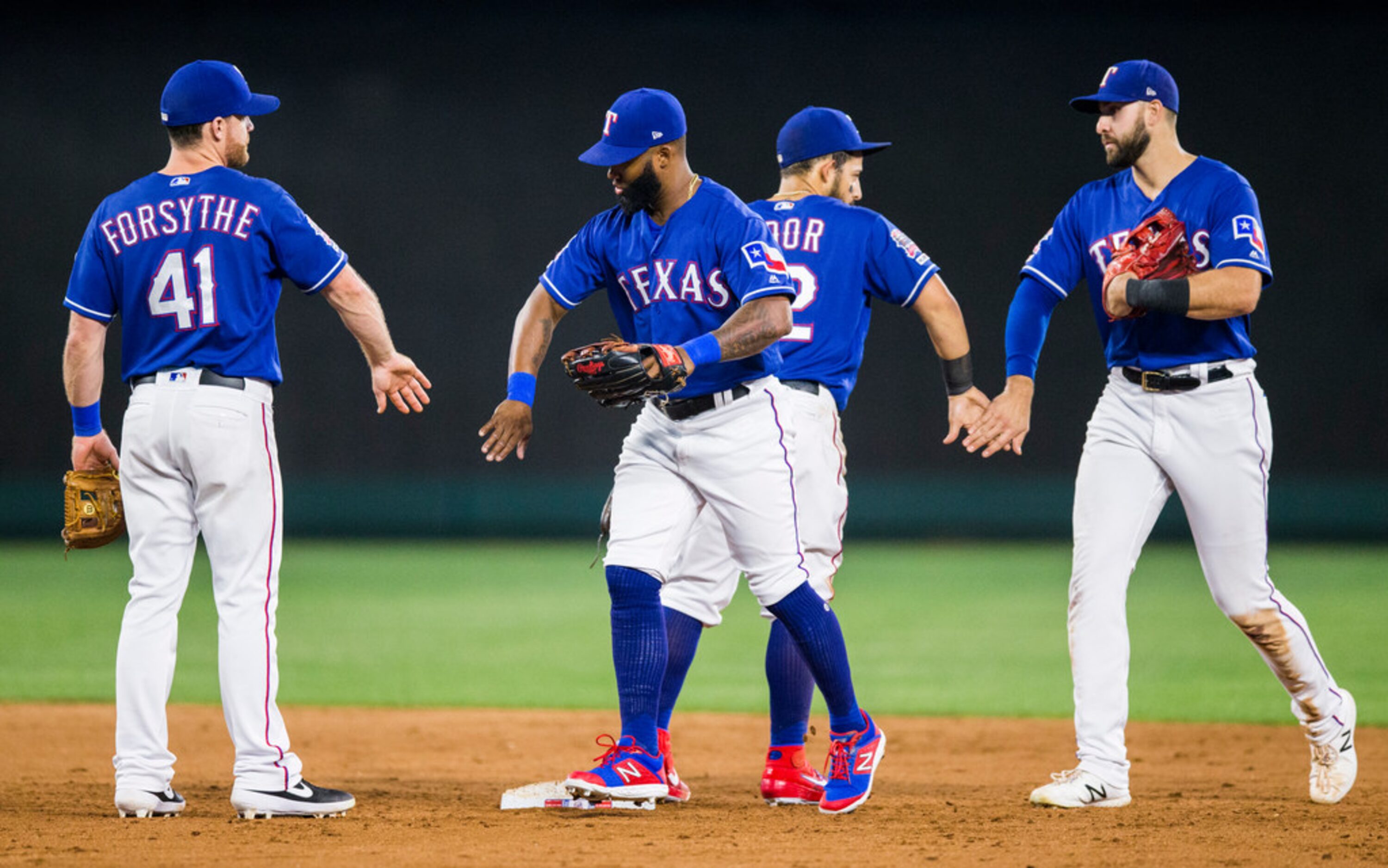 Texas Rangers celebrate a 5-3 walk off win over the Seattle Mariners on Tuesday, May 21,...