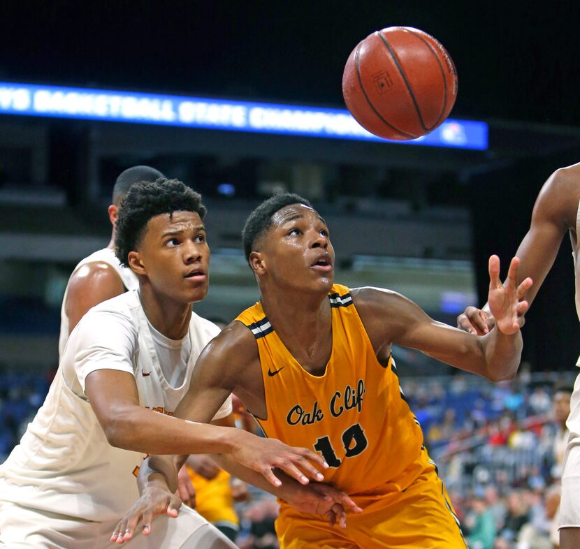 Oak Cliff Faith Family's Trae Clayton #10 reaches for a loose ball in front of Houston...