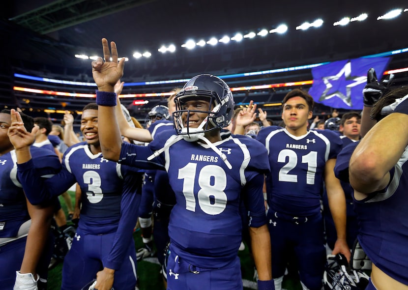 Frisco Lone Star quarterback Jason Shelley and his teammates listen to the school song...