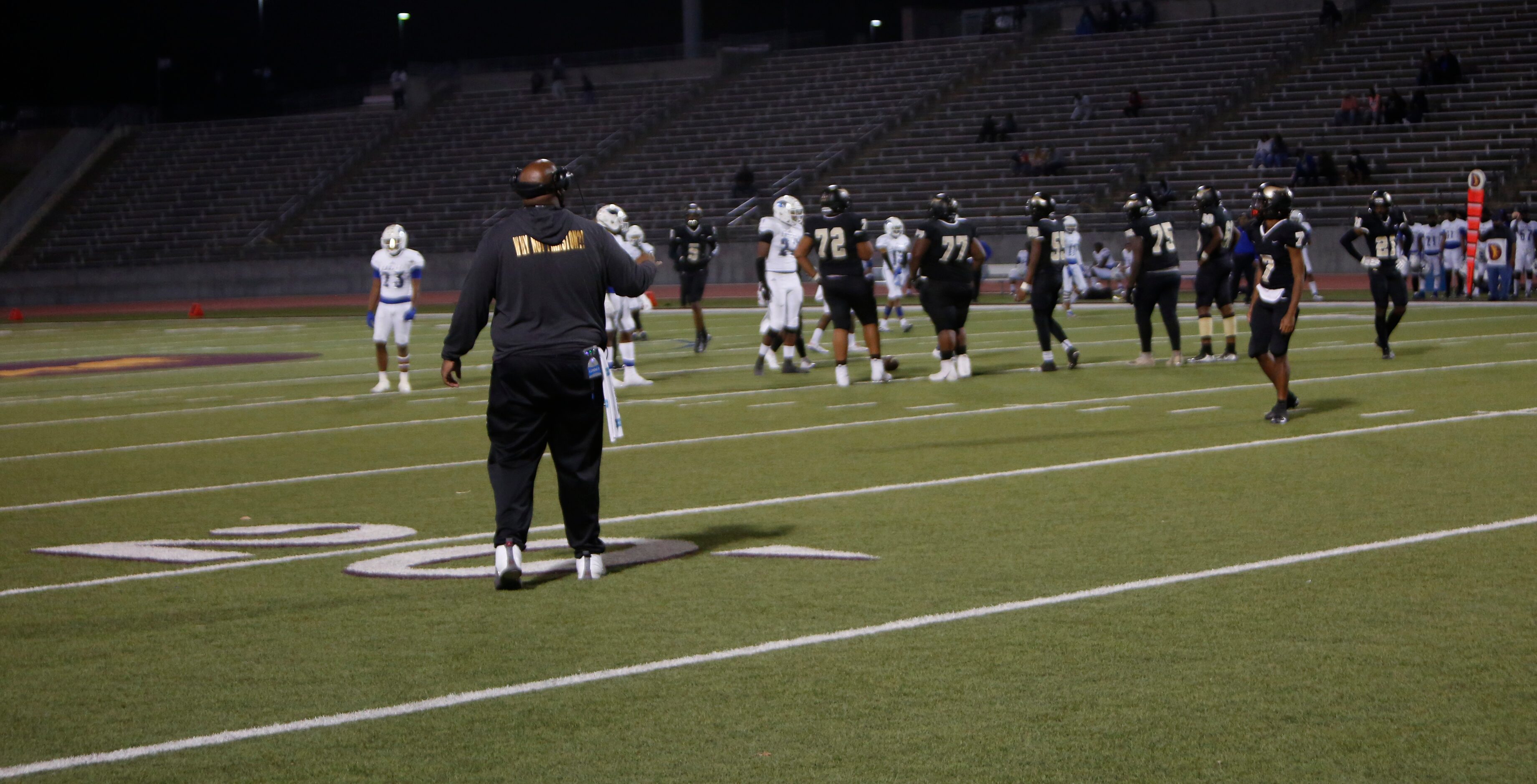 Dallas Pinkston assistant coach Gerulius Moore moves in to make sure his players understand...