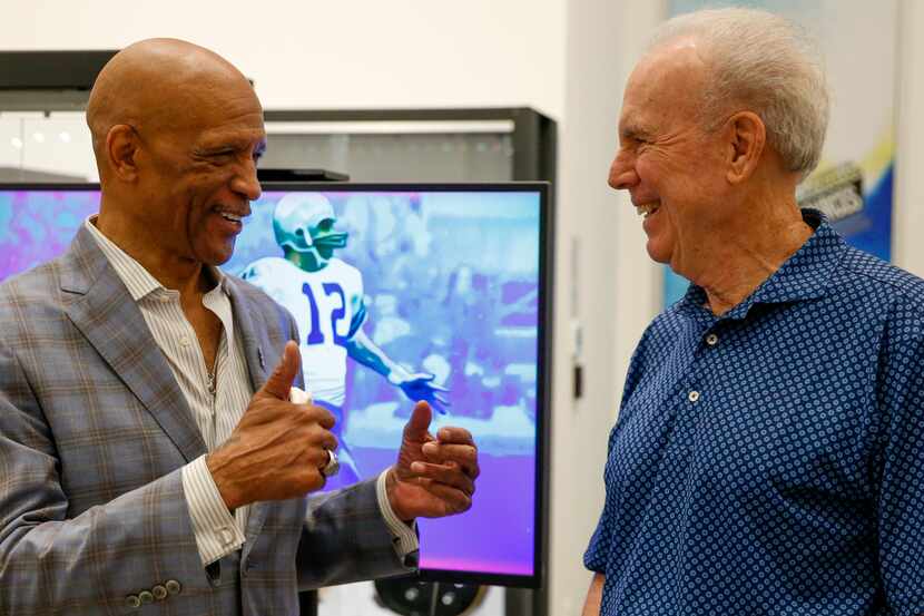 Former Dallas Cowboys players Drew Pearson (left) and Roger Staubach chat at the unveiling...