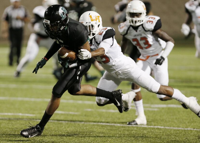 Lancaster defensive back Jaymir Sparrow (23) tackles Mansfield Lake Ridge Senior wide...