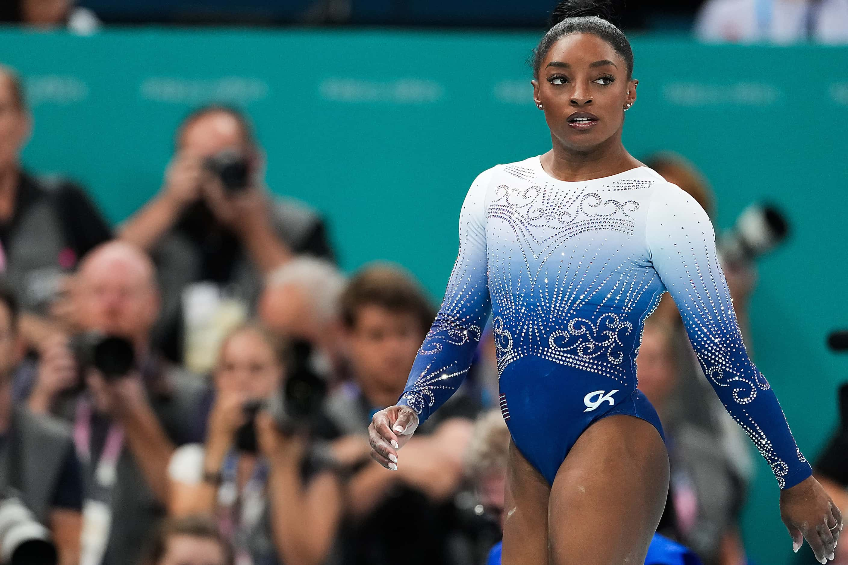 Simone Biles of the United States reacts after competing on the balance beam during the...