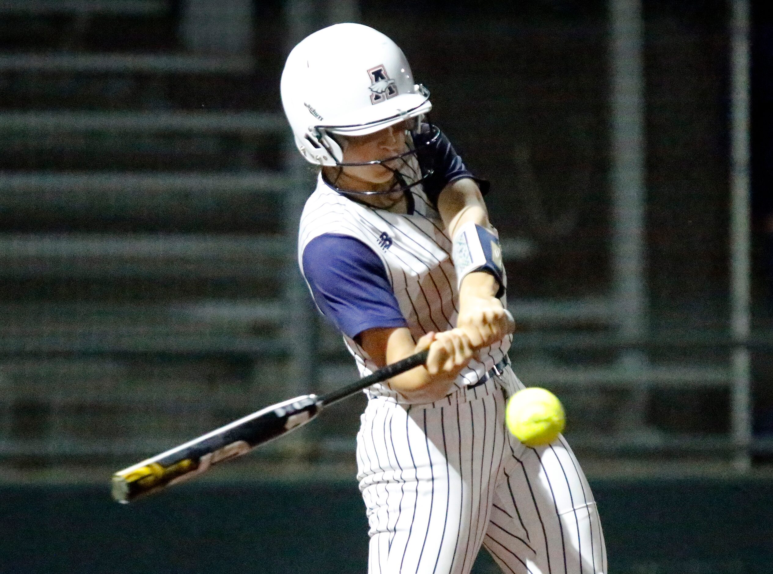 Allen High School shortstop Samantha Hood (4) makes contact in the first inning as Allen...