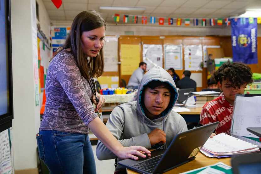 Teacher Autumn Slosser helps freshman Maynor Caal, who is learning English as a third...