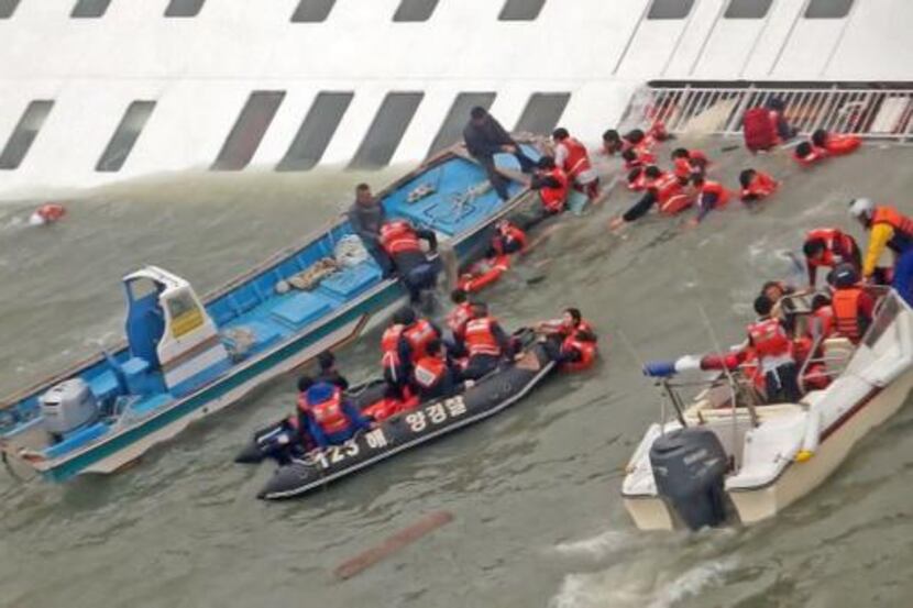 
South Korea Coast Guard members rescue some of the 475 passengers and crew aboard a South...