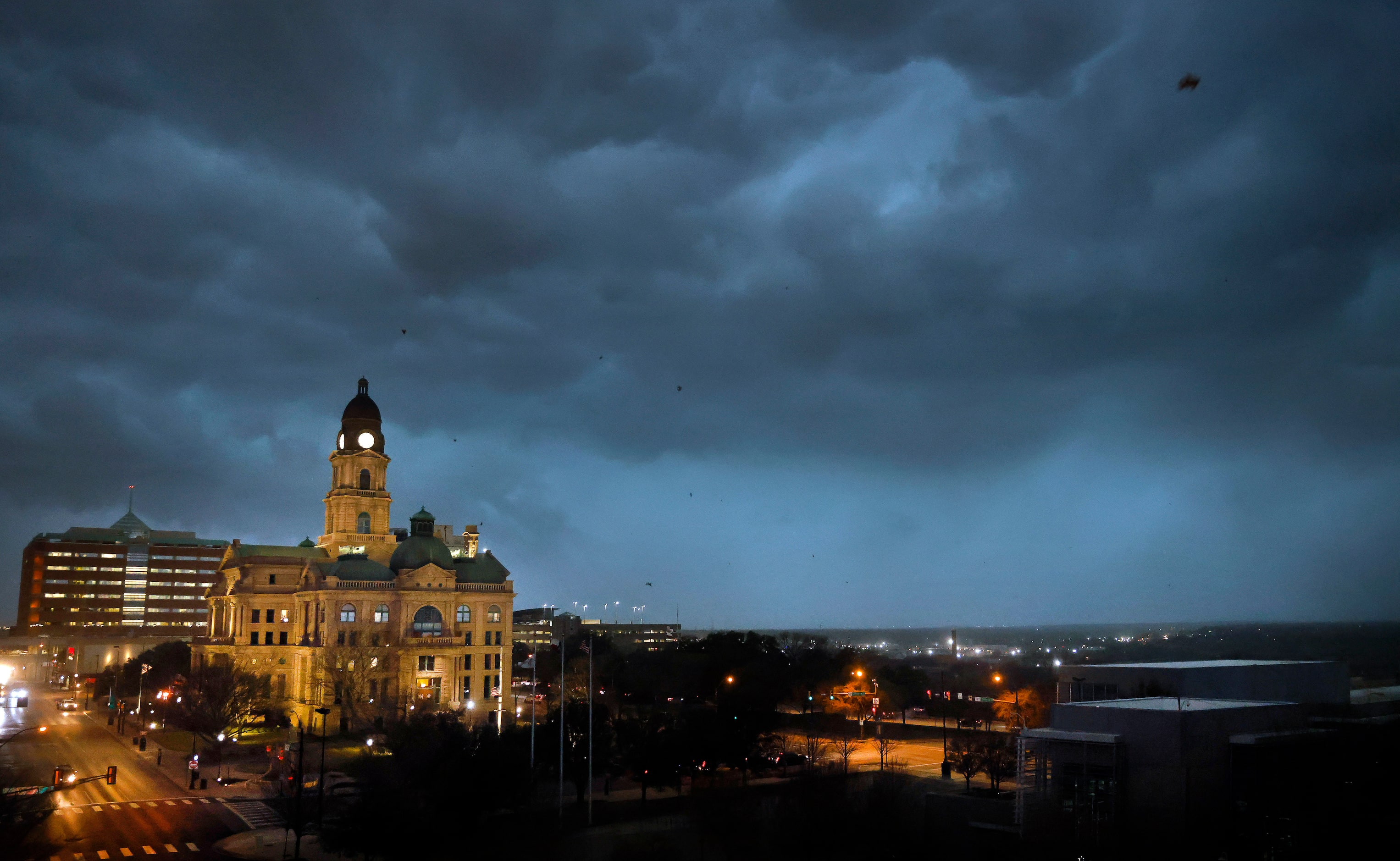 Debris flies through the air as howling winds accompanied by a line of storms approach the...