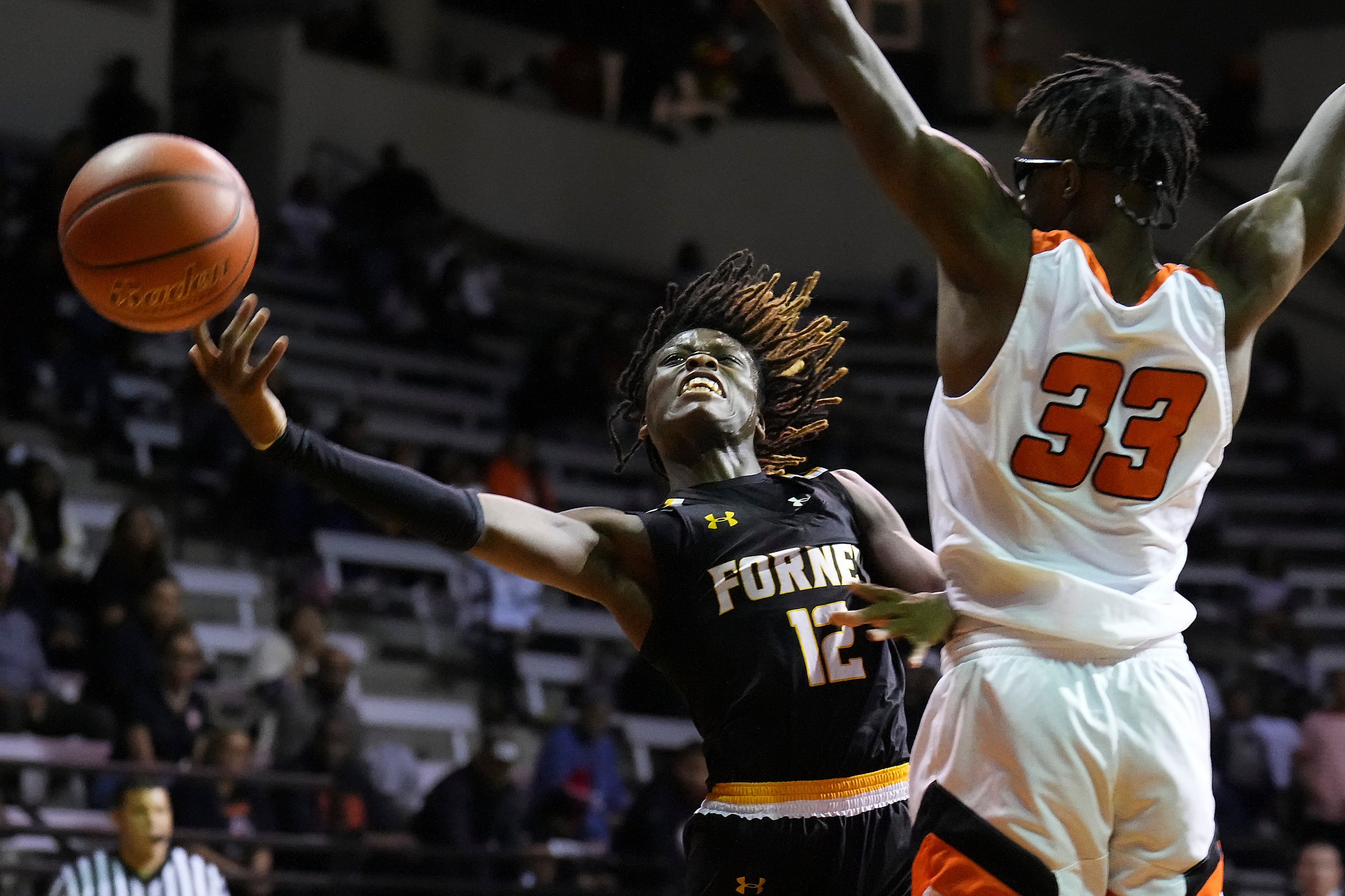 Forney’s Gernarius Edwards (12) loses the ball as he tries to drive around Lancaster’s Amari...