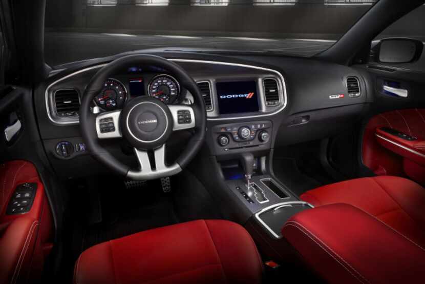Inside the 2013 Dodge Charger SRT8,  black-faced gauges and a leather-covered steering wheel...